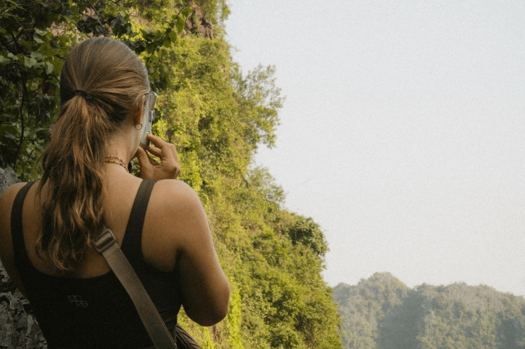 a person standing on a cliff overlooking a river