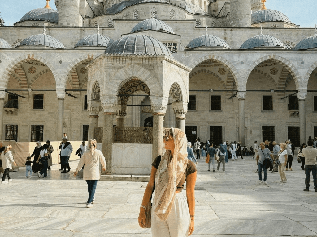 a person is standing in front of the blue mosque in istanbul