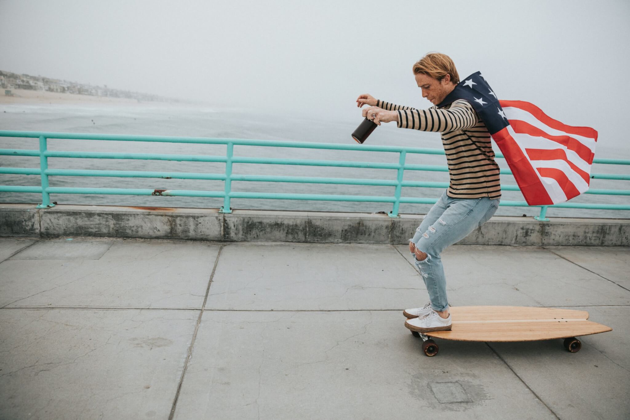 man skateboarding with american flag