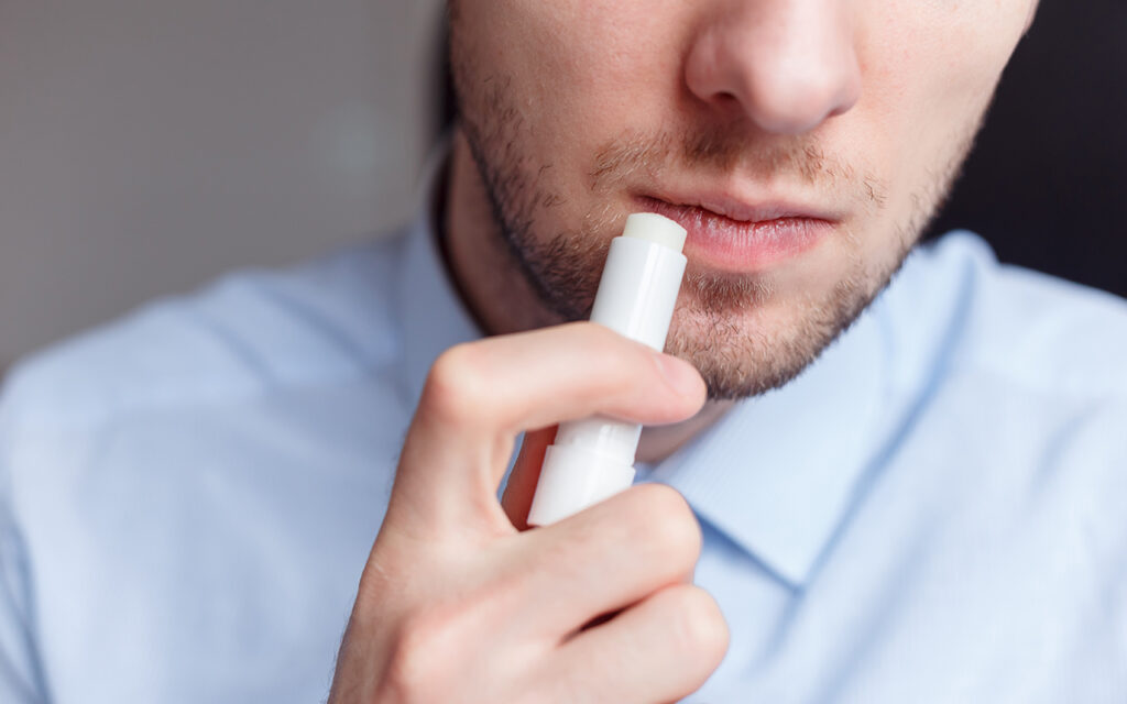 Man applying chapstick