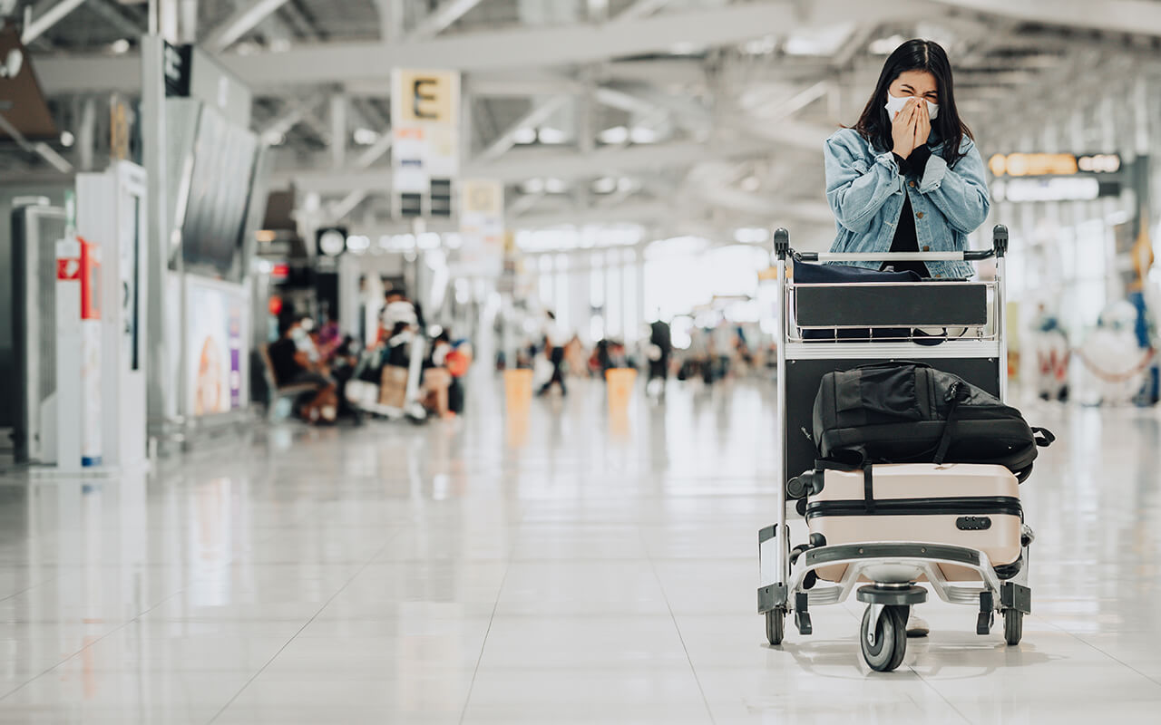 Woman sneezing at an airport