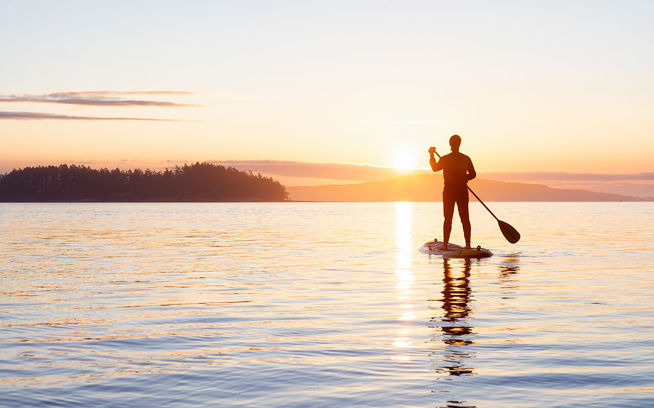 Adventurous Adult Woman on a Stand Up Paddle Board 