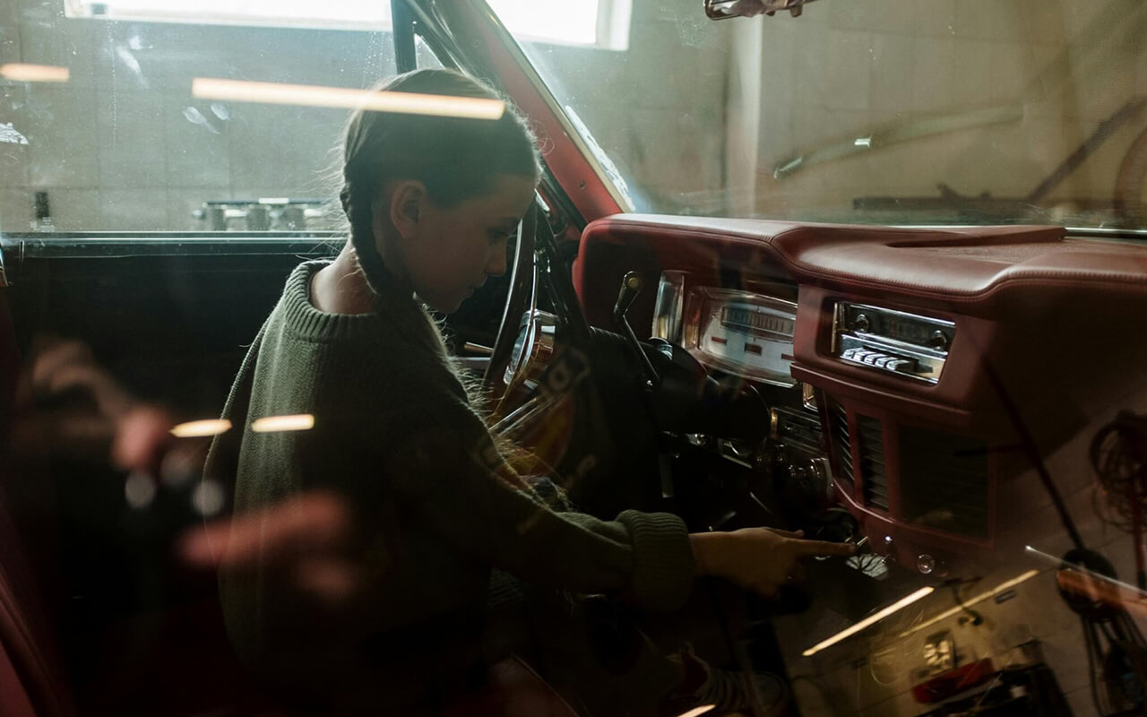 Child playing with the radio in a car