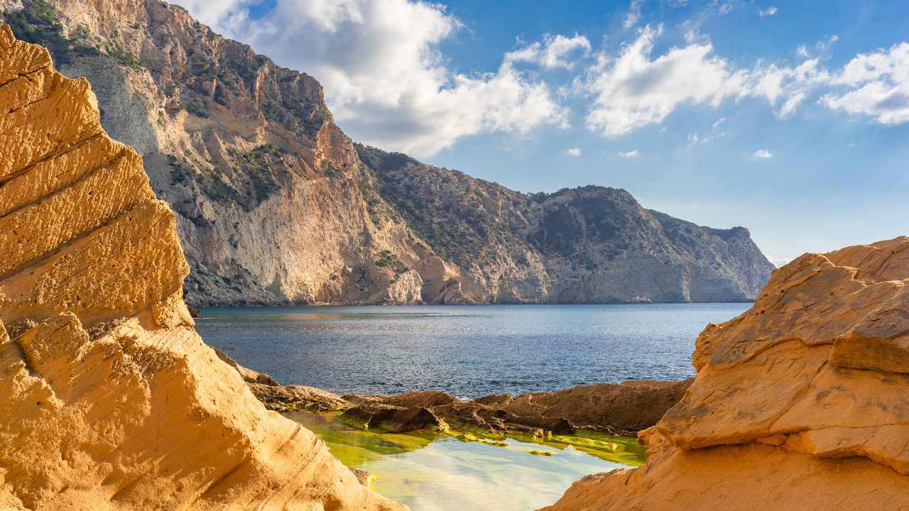 the view from a cliff overlooking the ocean in greece