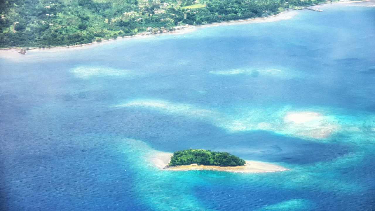 an aerial view of an island in the middle of the ocean