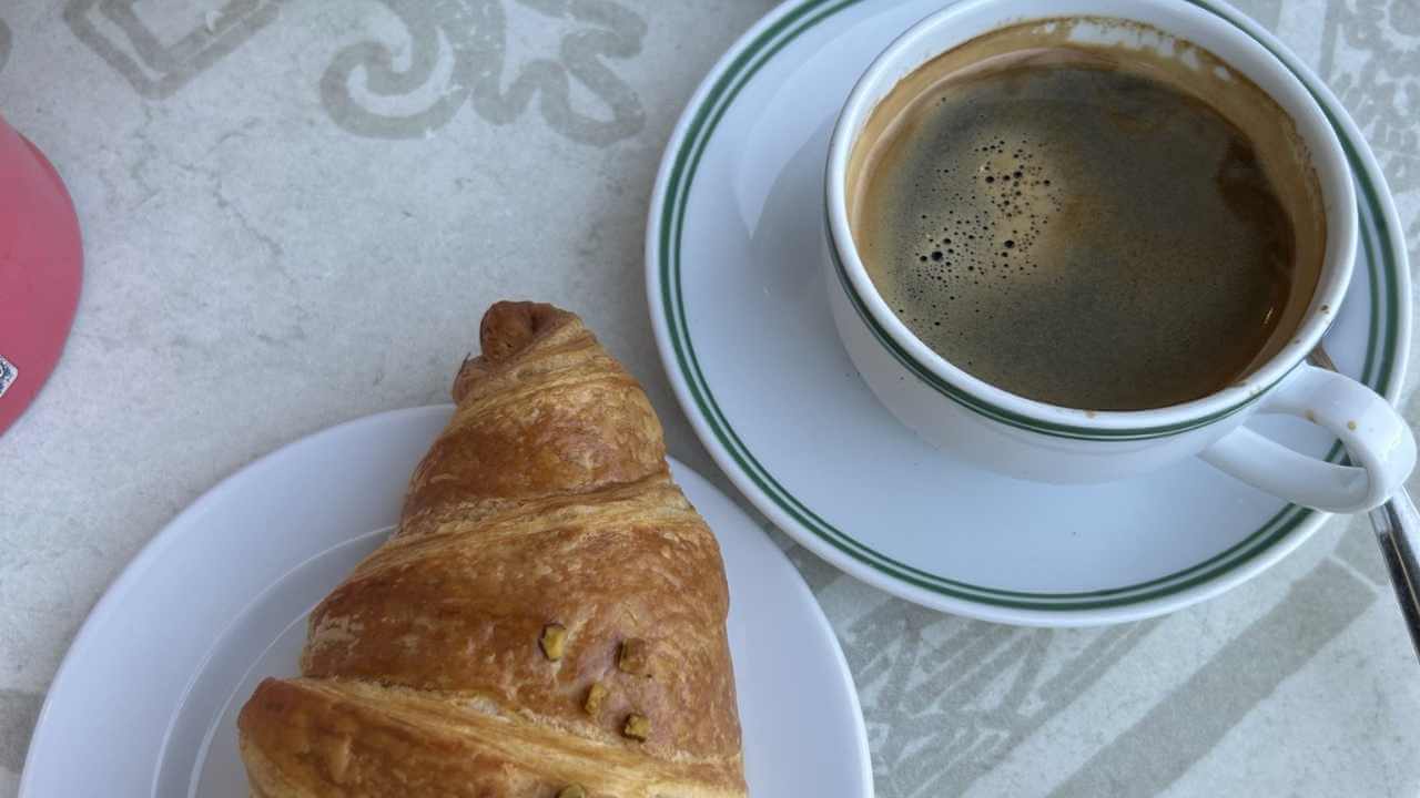 coffee and a croissant on a table