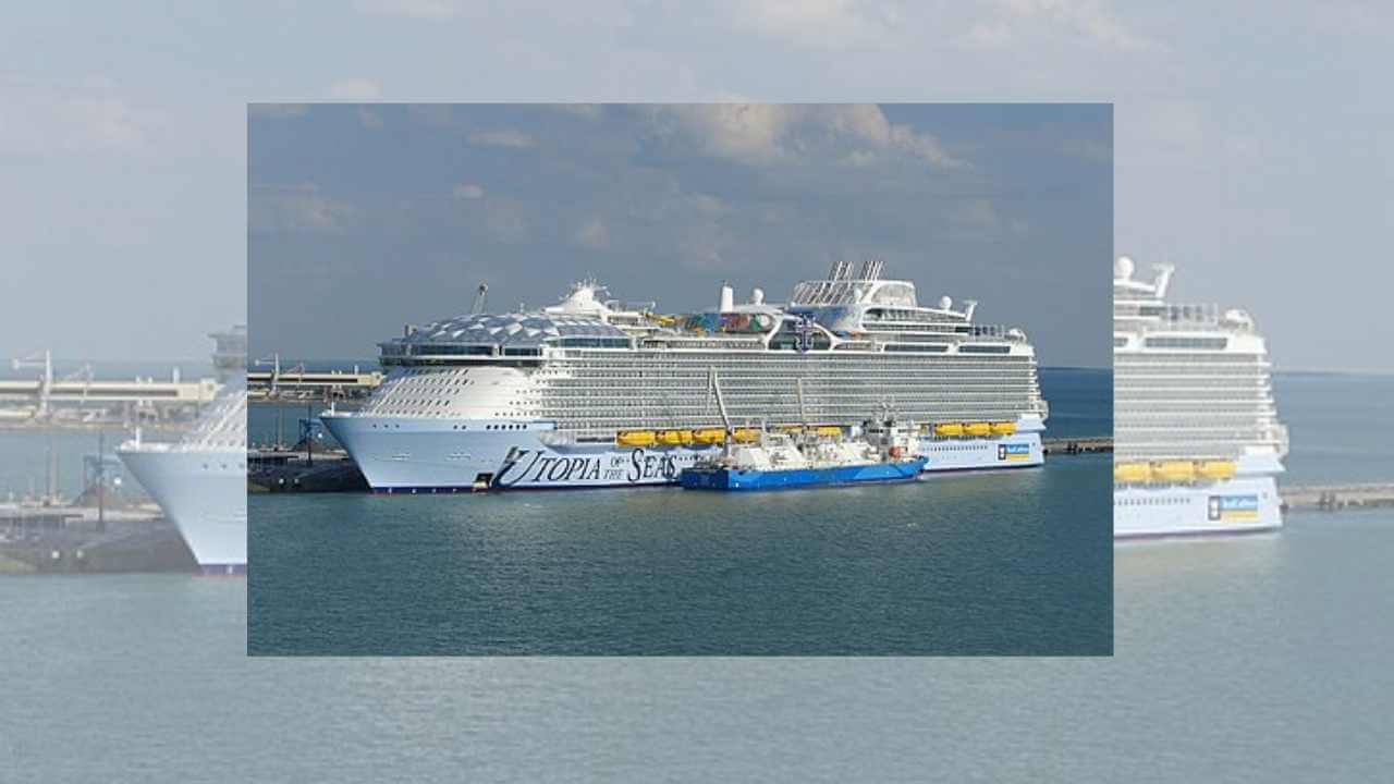 a large cruise ship docked next to a pier