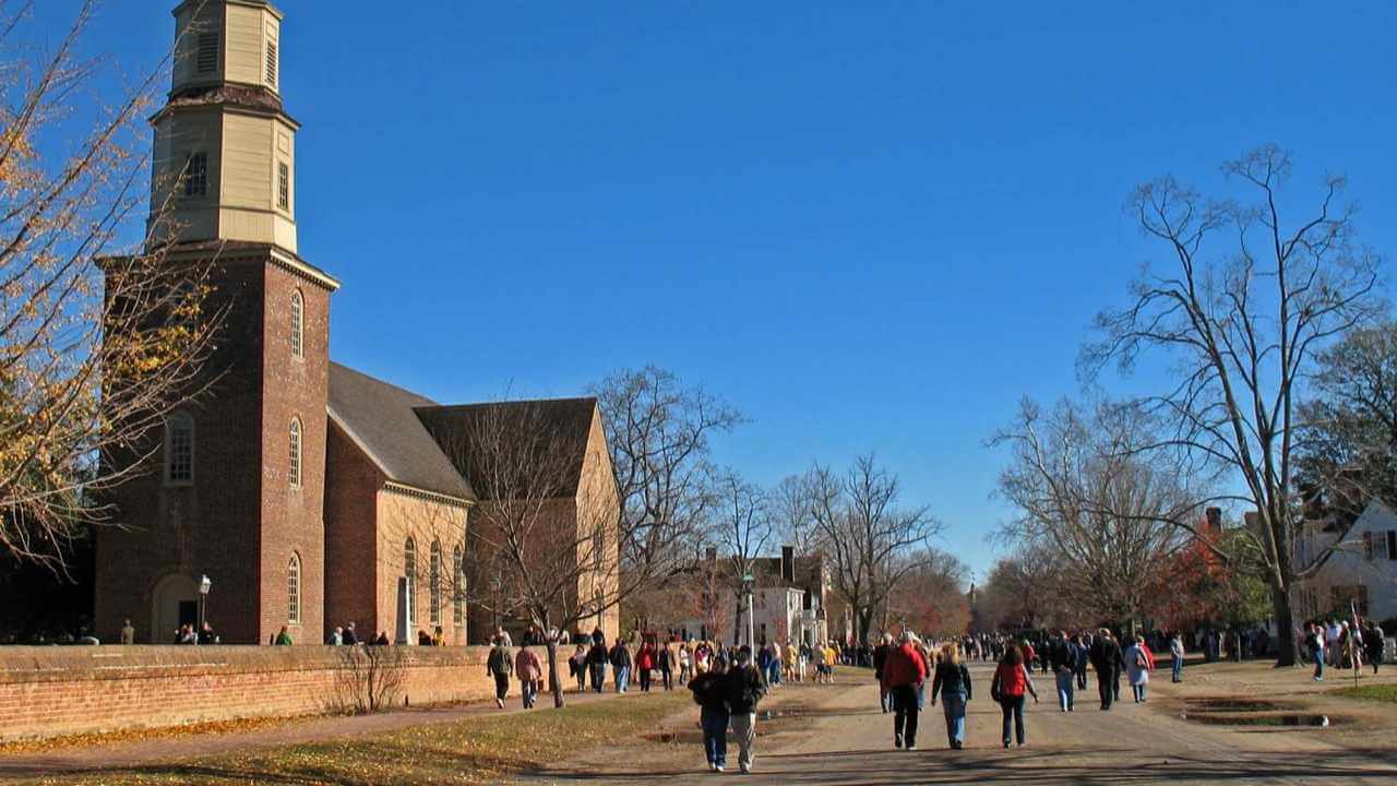 a group of people walking in front of a church