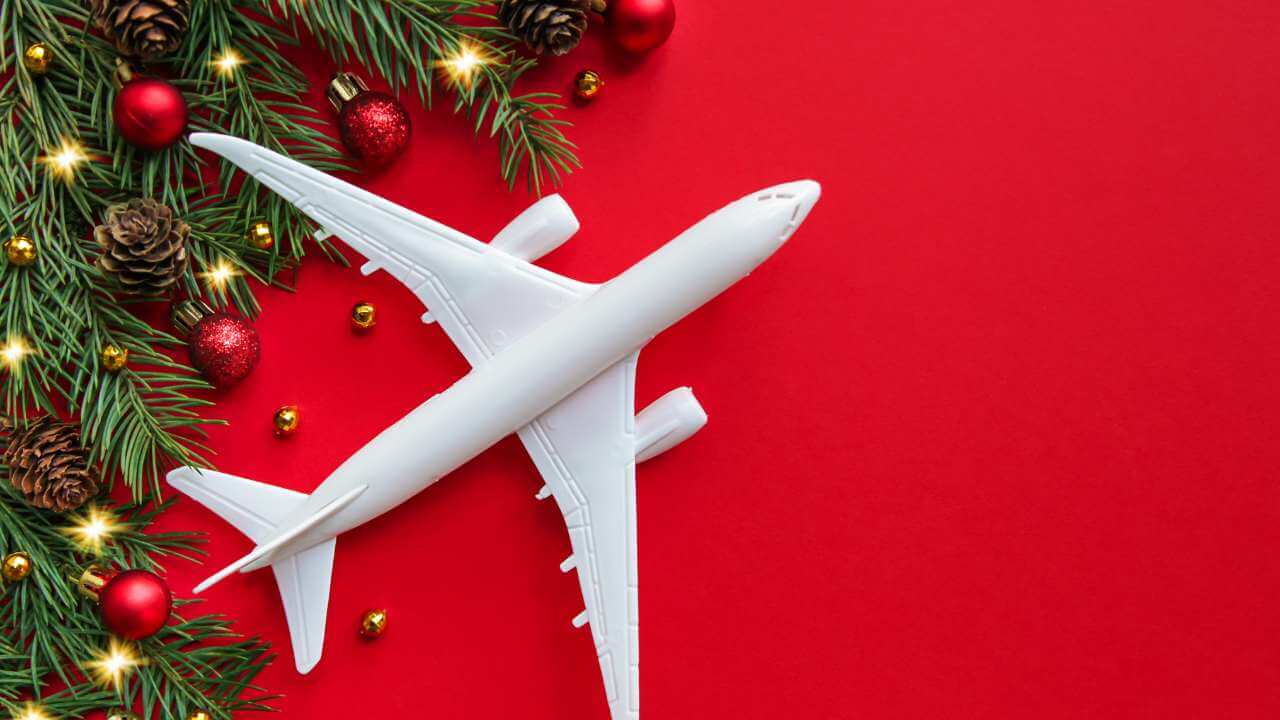 christmas tree and plane on red background - christmas stock pictures and royalty-free photos