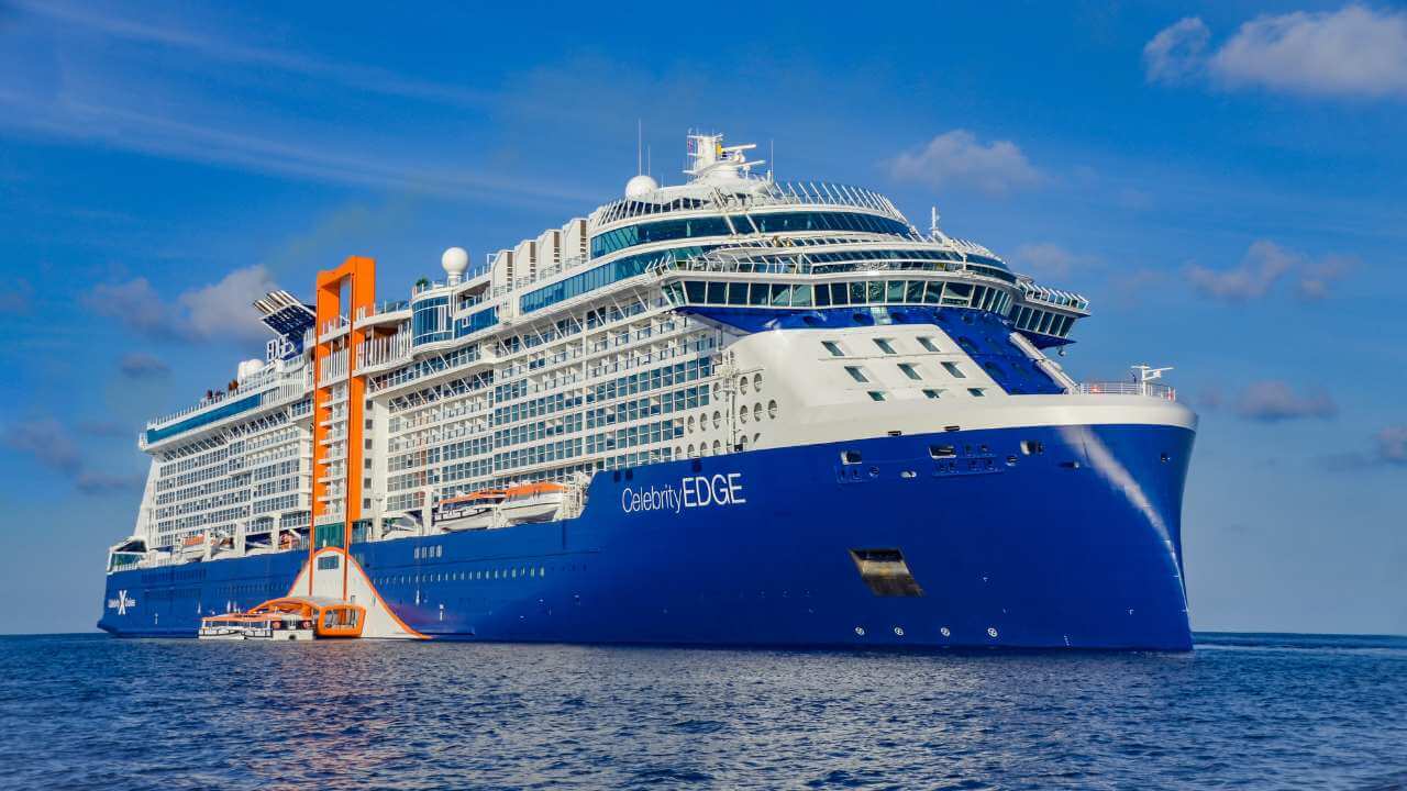 a large blue and white cruise ship in the ocean