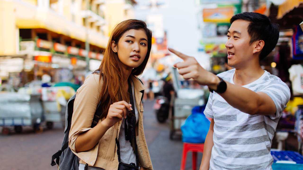 a person and person pointing at something on the street