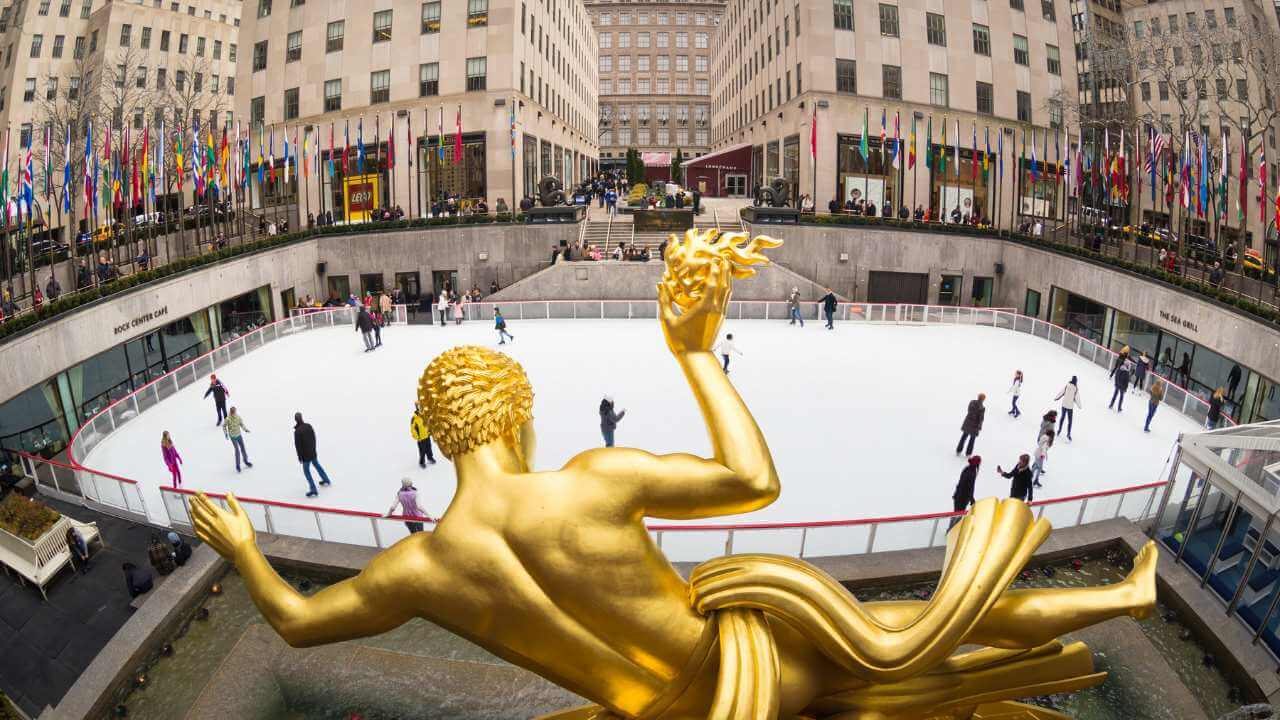 an image of a golden statue in the middle of a city