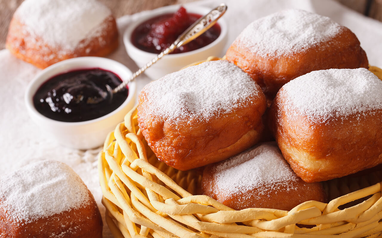 Beignets covered with powdered sugar, served with cafe au lait at the famous Cafe Du Monde in the French Quarter.