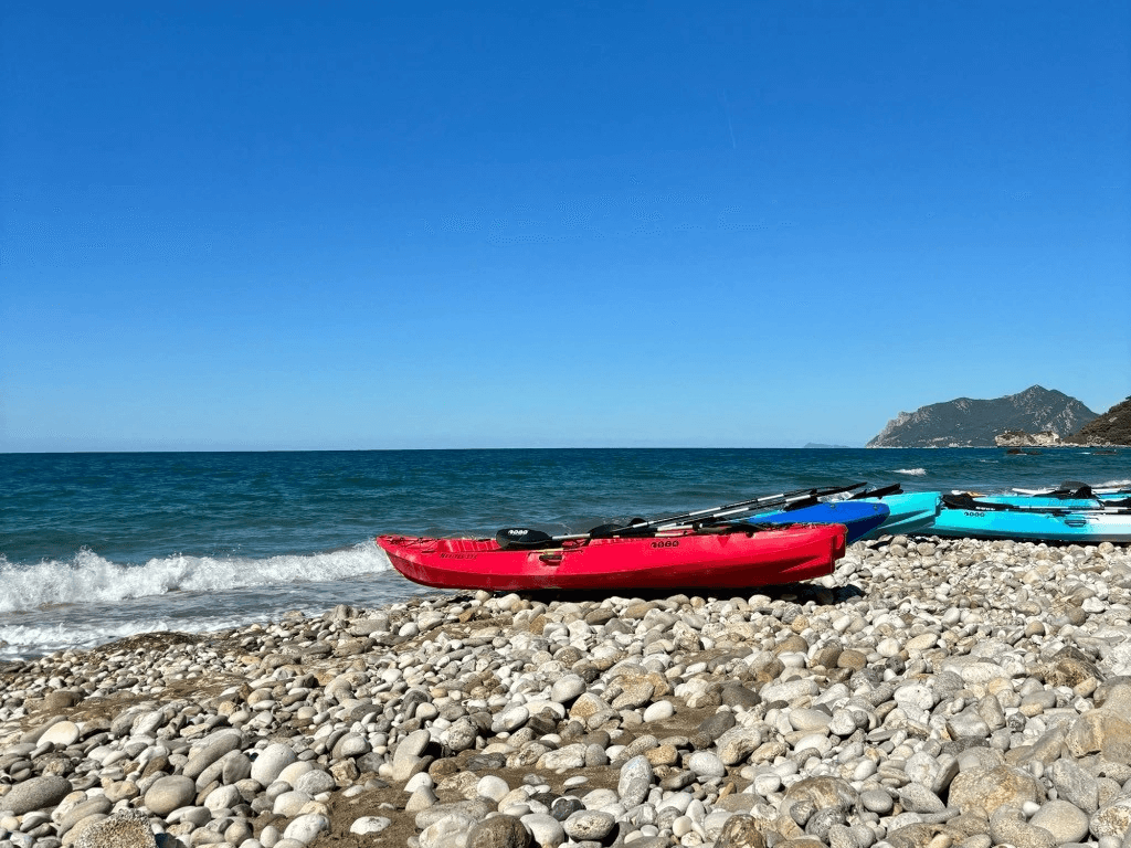 kayaks laying on the rocky beach