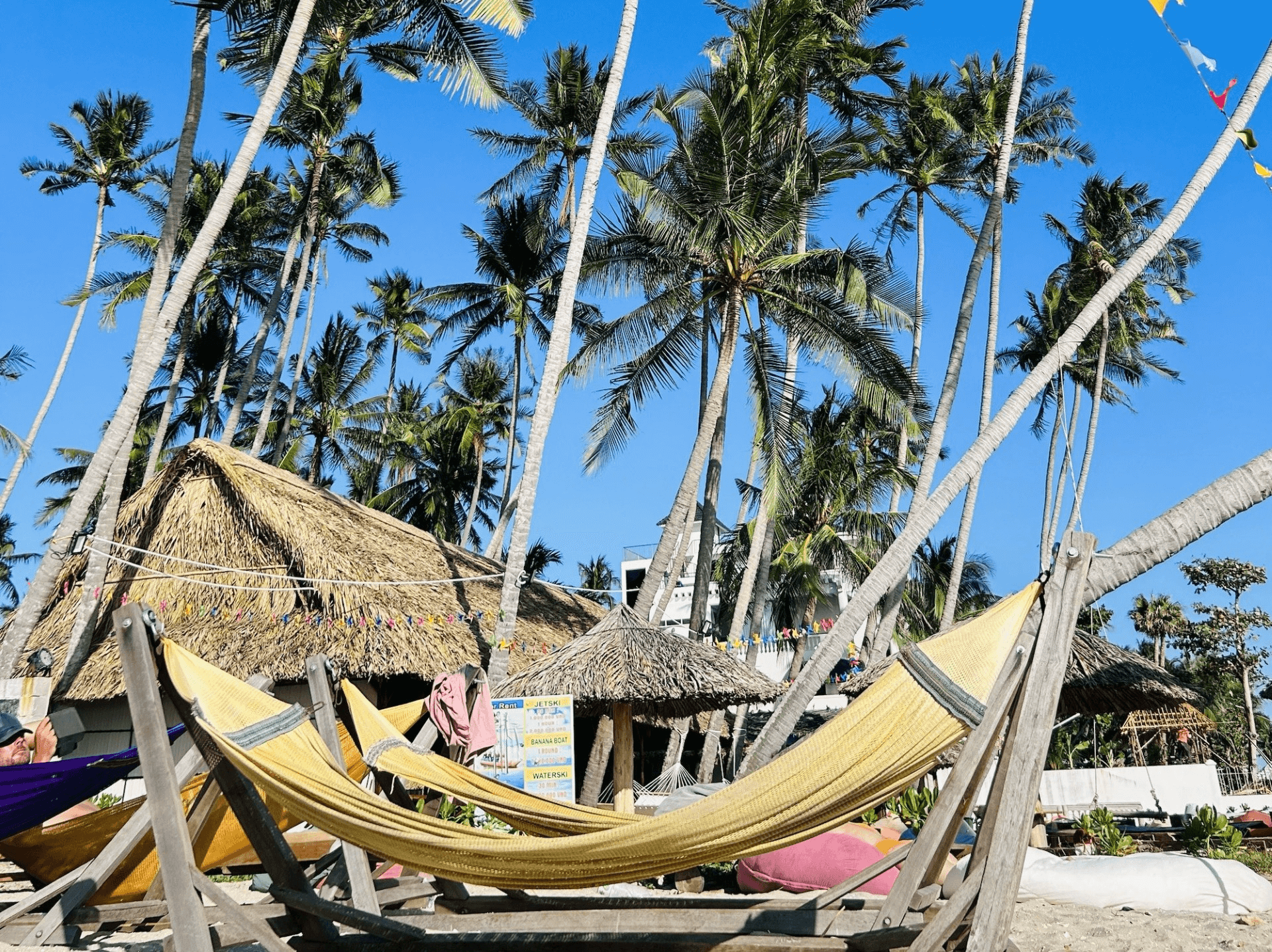 hammocks and jet ski rentals with palm trees