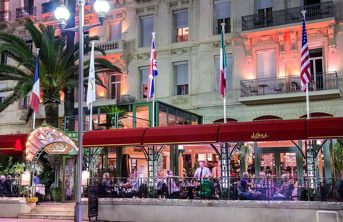 people sitting outside at a french restaurant 