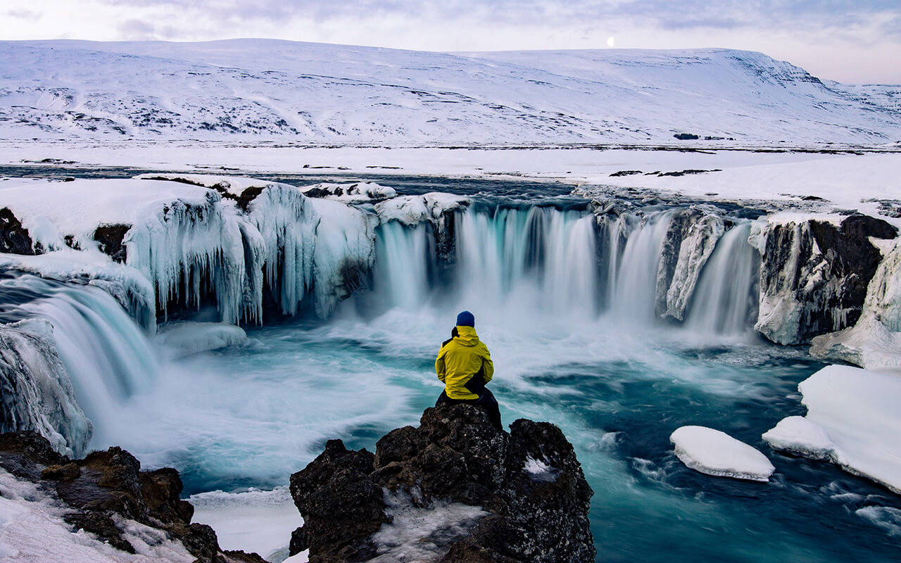 Adventurous man at Godafoss, Iceland in winter