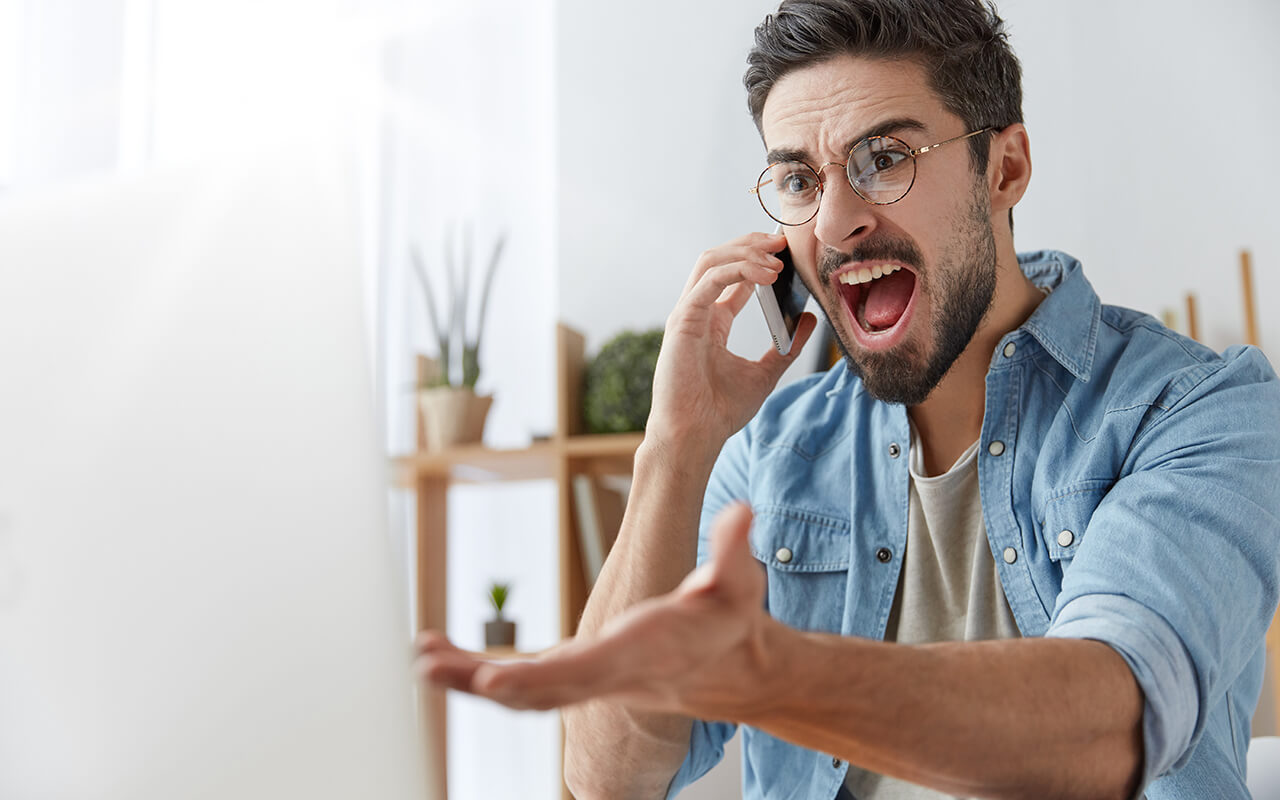 Angry man speaking on the phone 