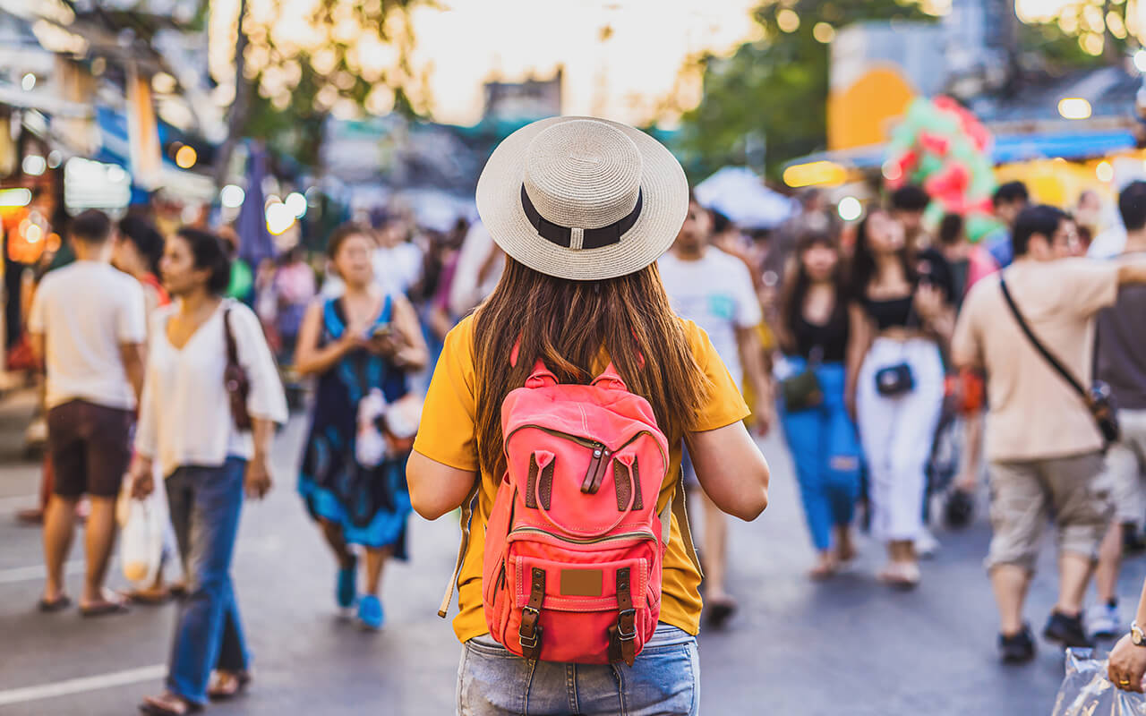 Tourist with a backpack walking in a city