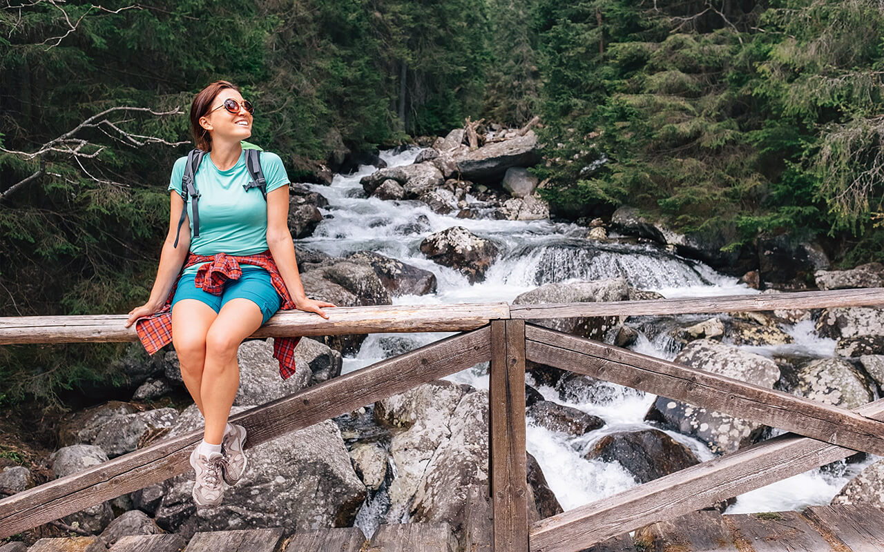 Woman sitting on bridge outdoors 