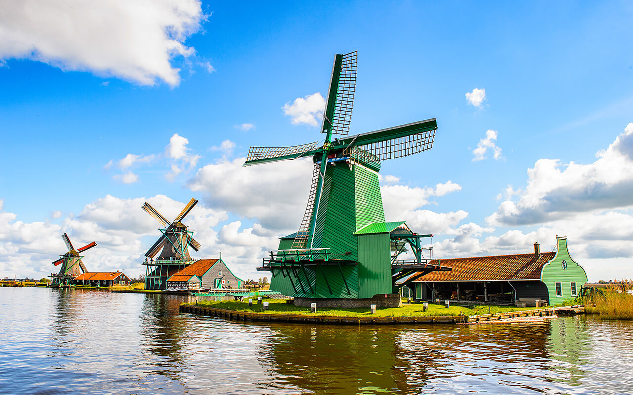 Windmills over a body of water