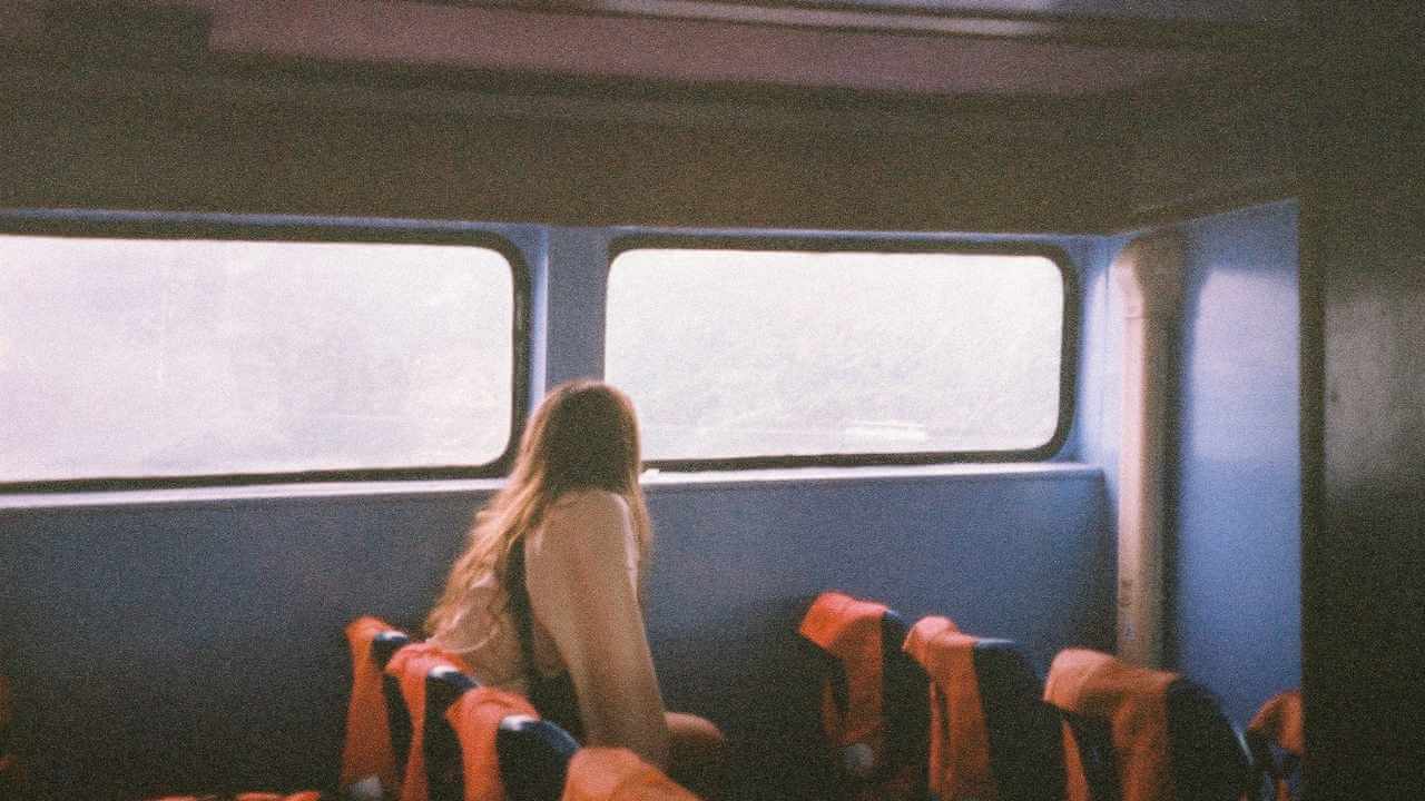 a person sitting on a bus looking out the window