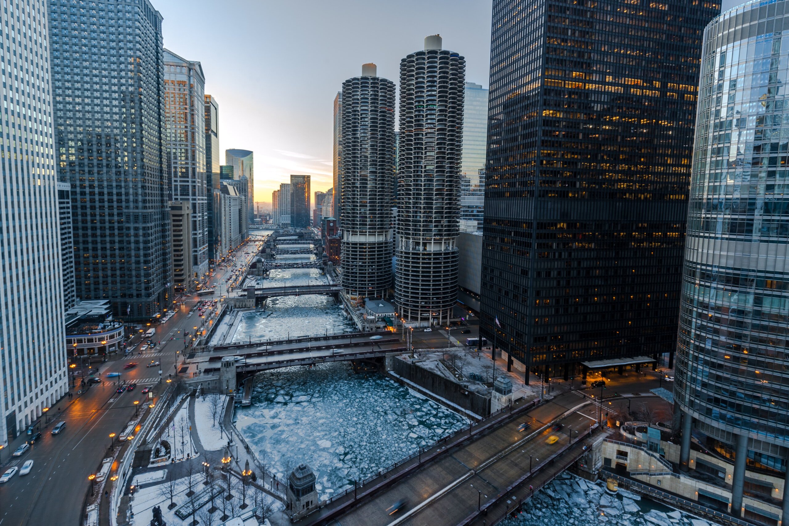 Winter sunset over the frozen Chicago River with city skyline