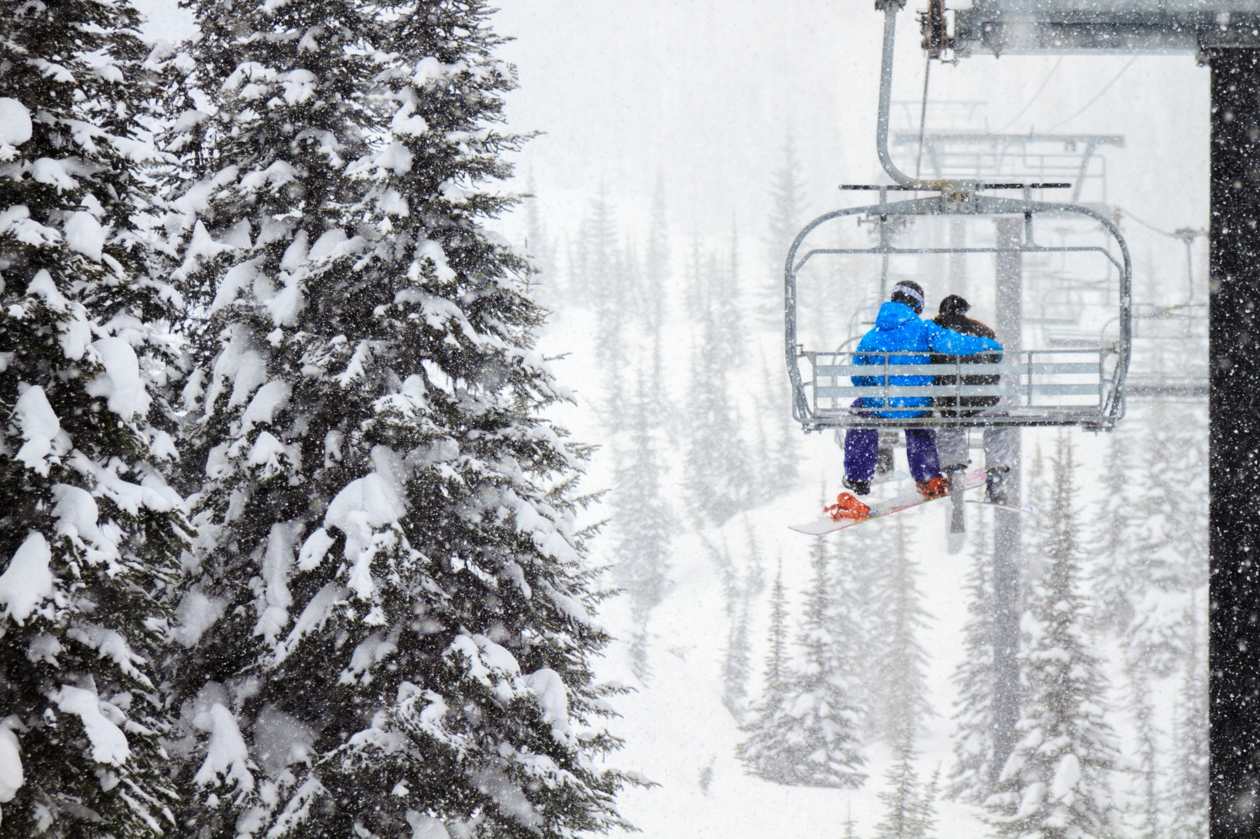 Skiing Couple On Chairlift

