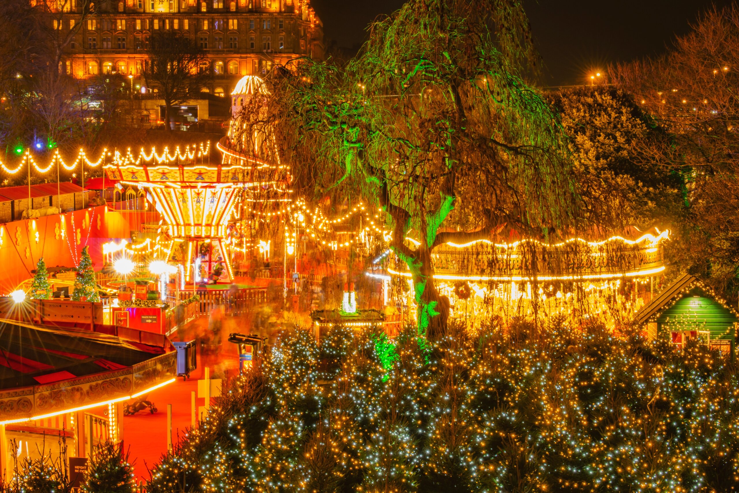 Edinburgh Christmas Market Fair Panorama night view long exposure of streets light Edinburgh sky line
