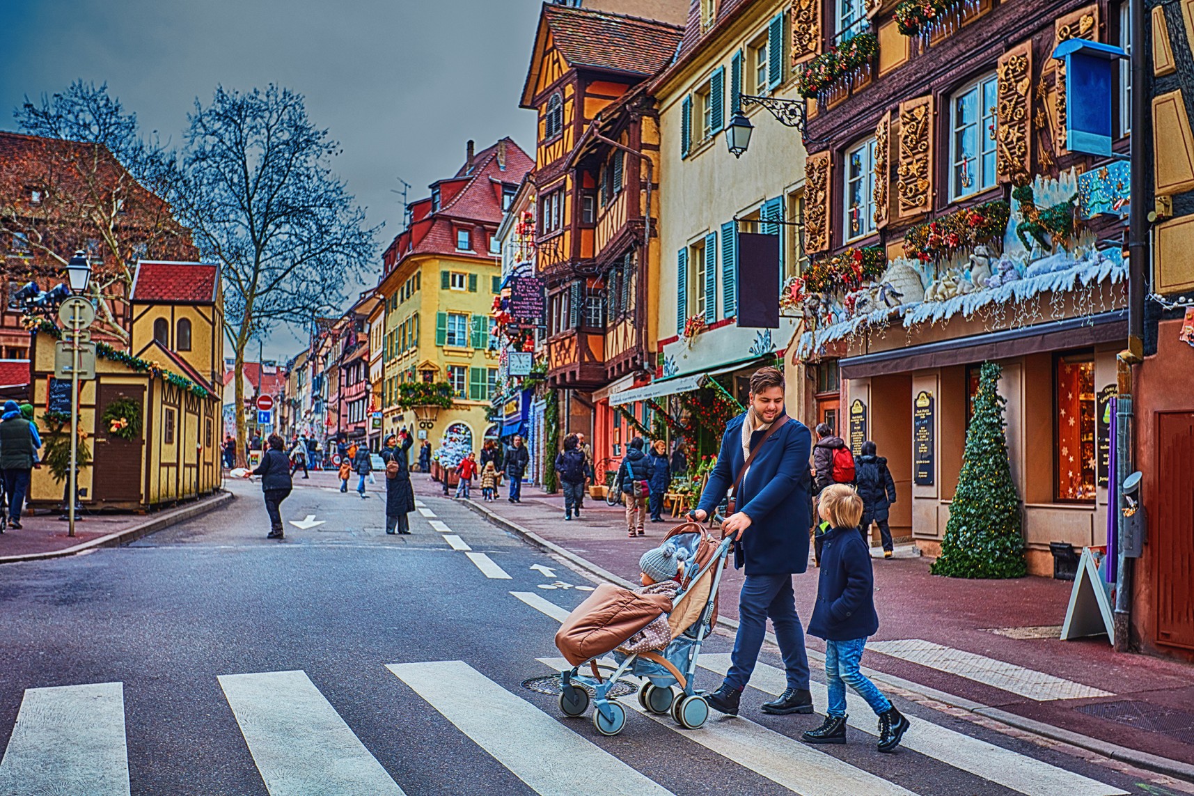 happy people crossing the street of Colmar town during Christmas holidays. Alsace, France

