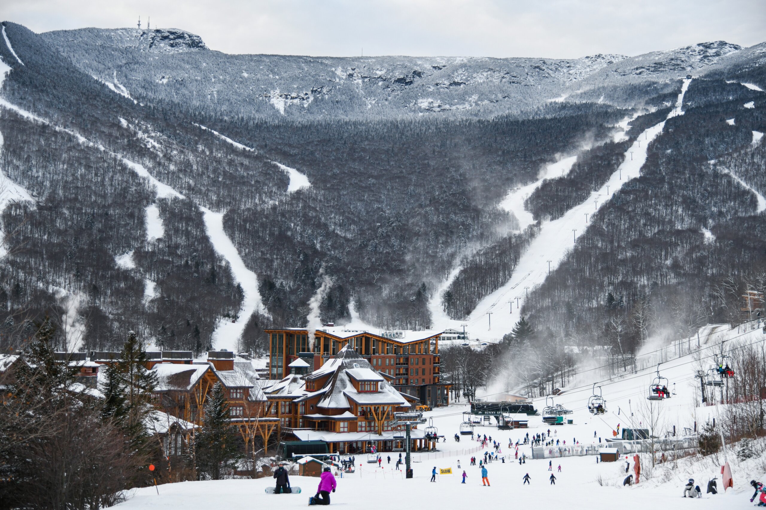 View from Spruce Peak to Stowe Mountain Resort Village and ski trails at Peak Mansfield.
