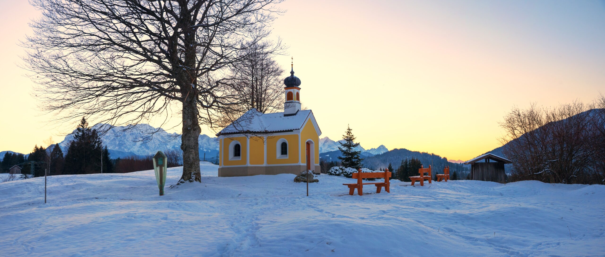 pilgrimage chapel in snowy winter landscape, colorful sunset scenery upper bavaria

