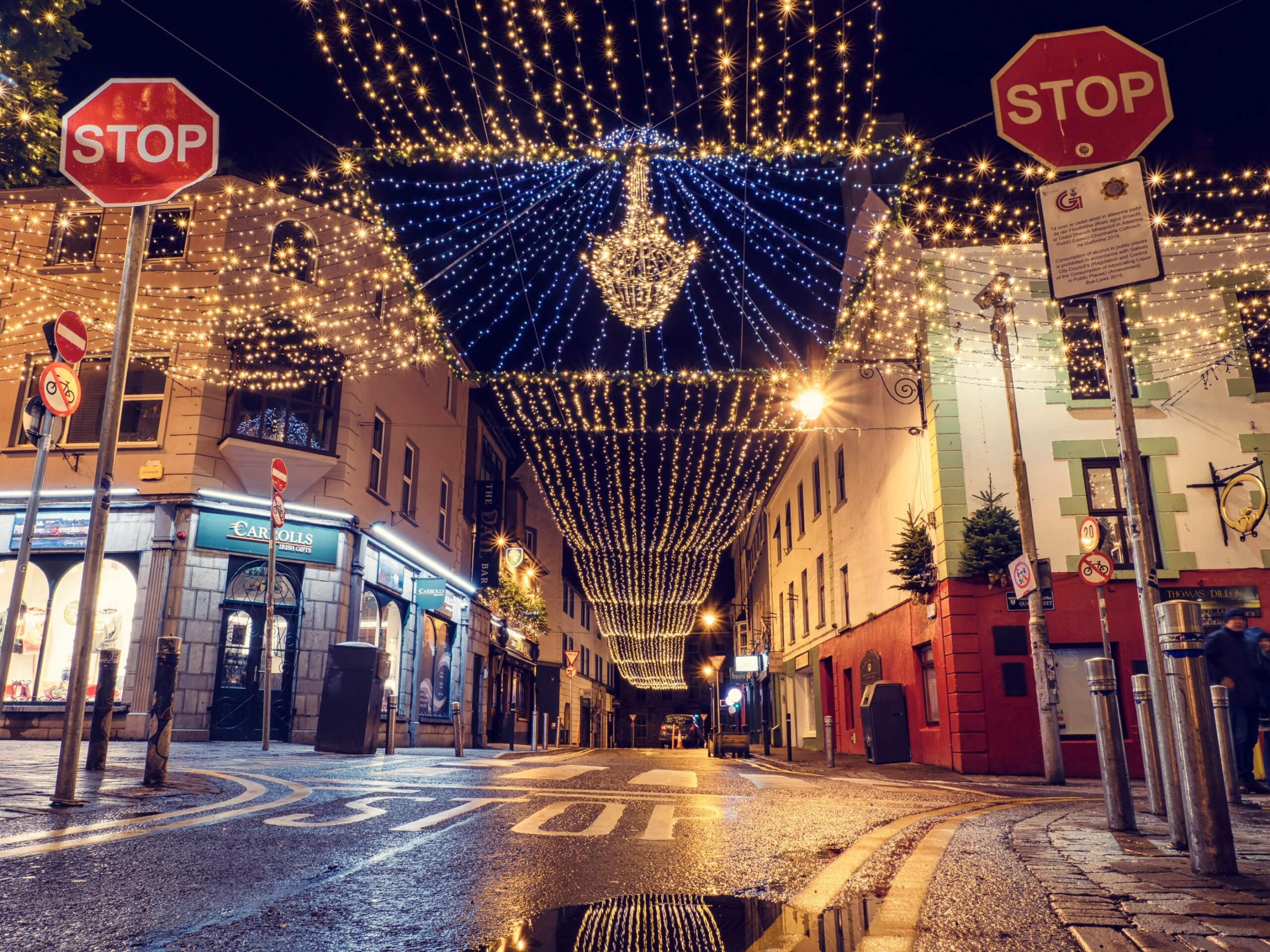 Galway, Ireland - 12.25.2022: Illuminated and decorated Shop street in the town center. Celebrating Christmas time theme. Low angle of view. Popular city area. Winter holiday. See Less
