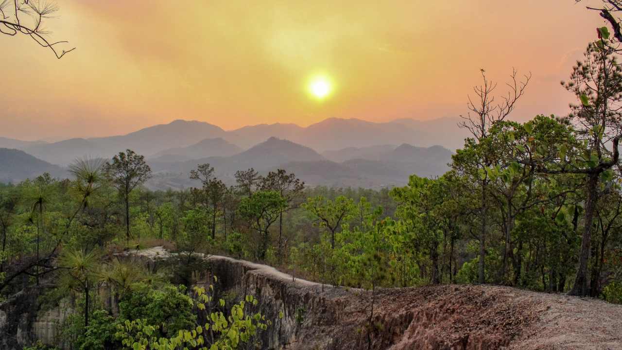 the sun is setting over the mountains in this photo