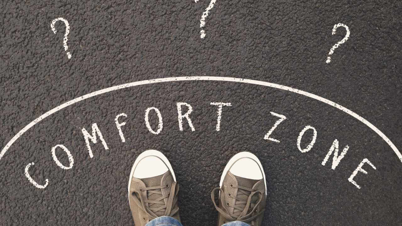 a person standing on a road with the words comfort zone written on it