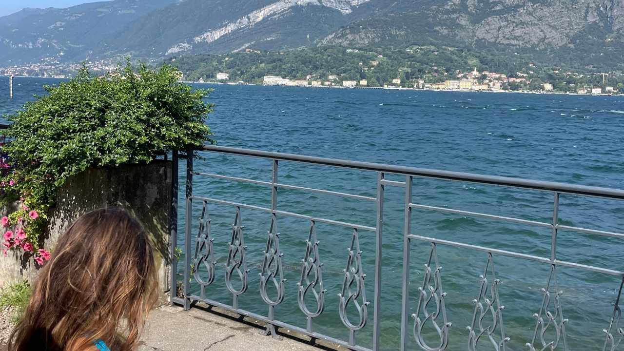 a person sitting on a bench near the water