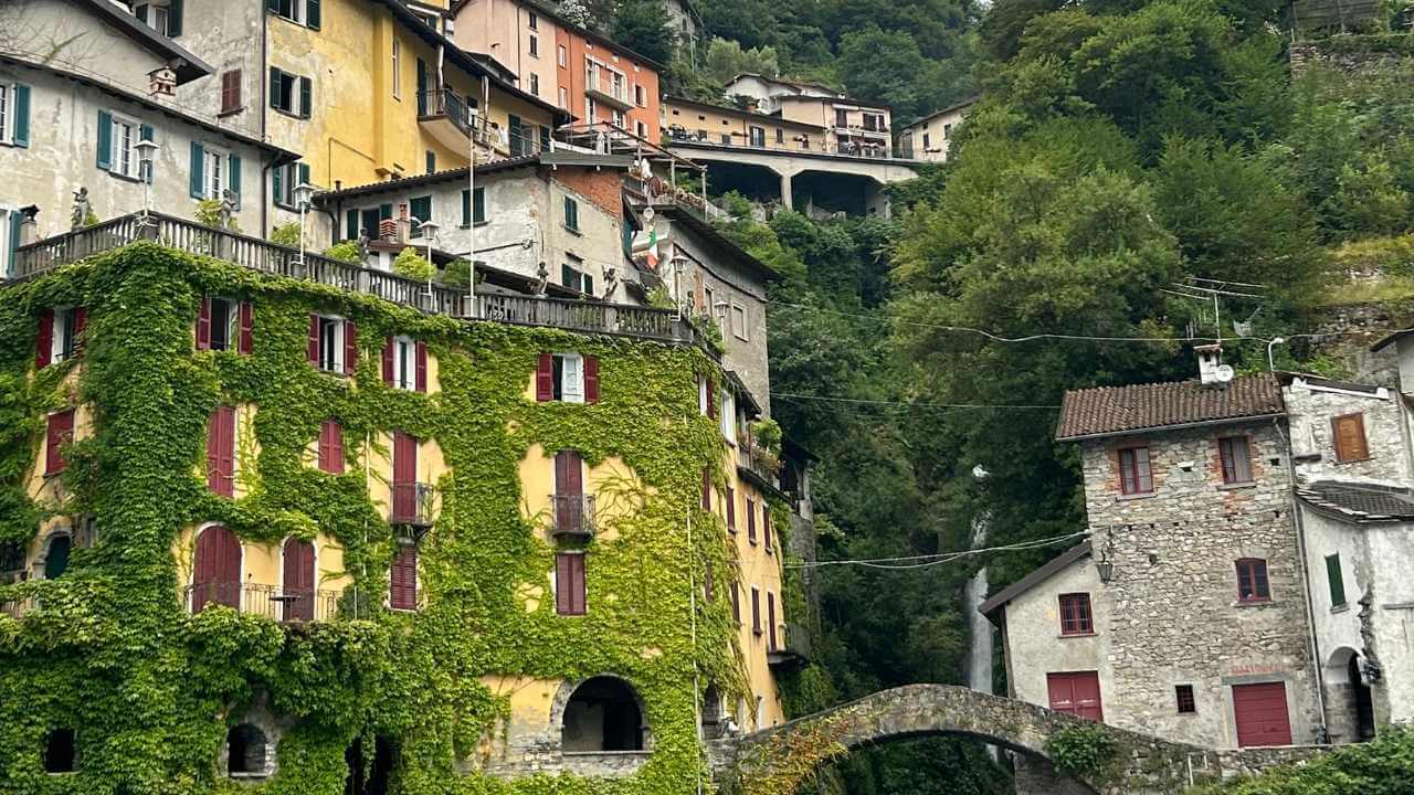 Colorful houses line the banks of a river in Italy