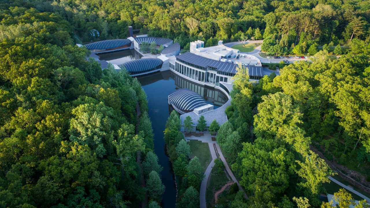 an aerial view of a large building surrounded by trees