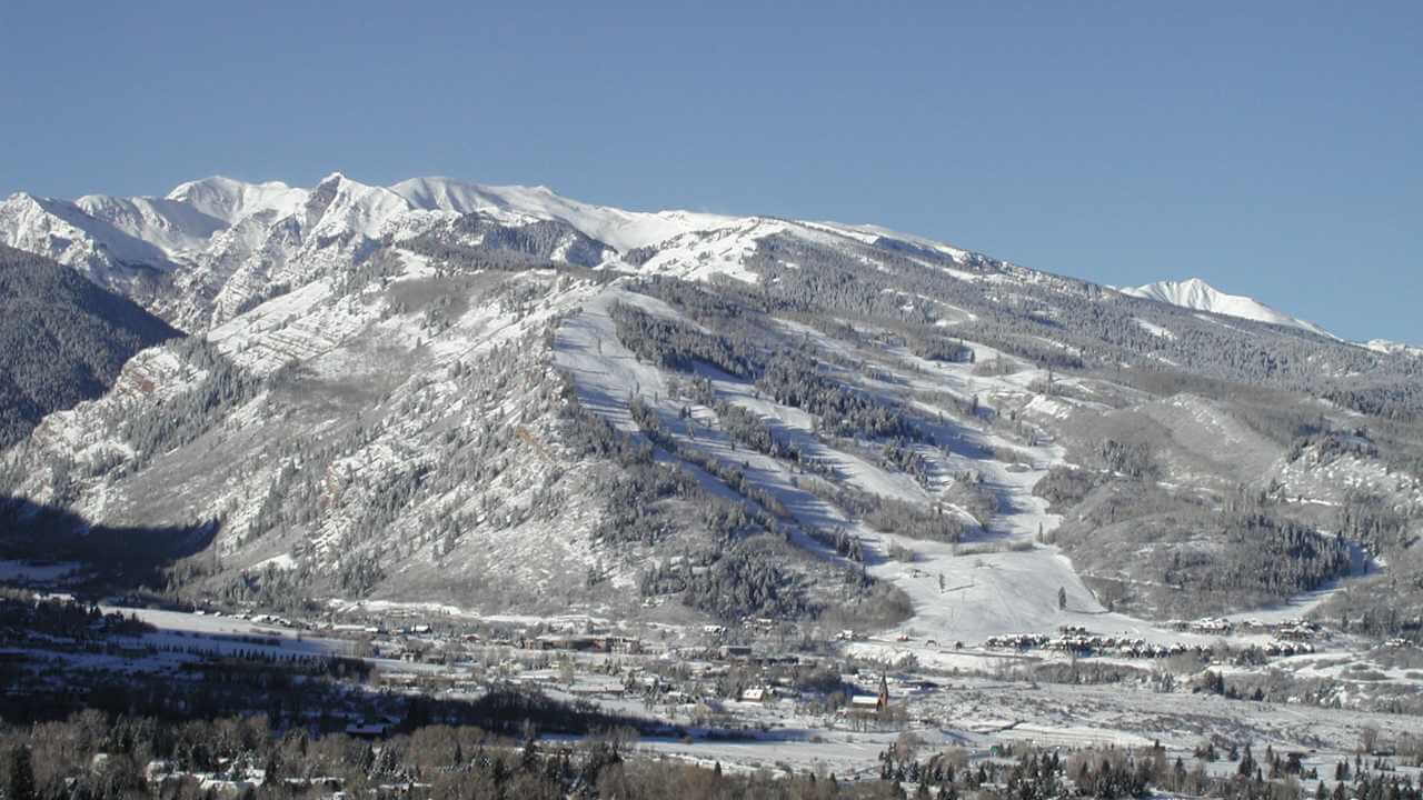 a view of a snowy mountain range from a ski resort