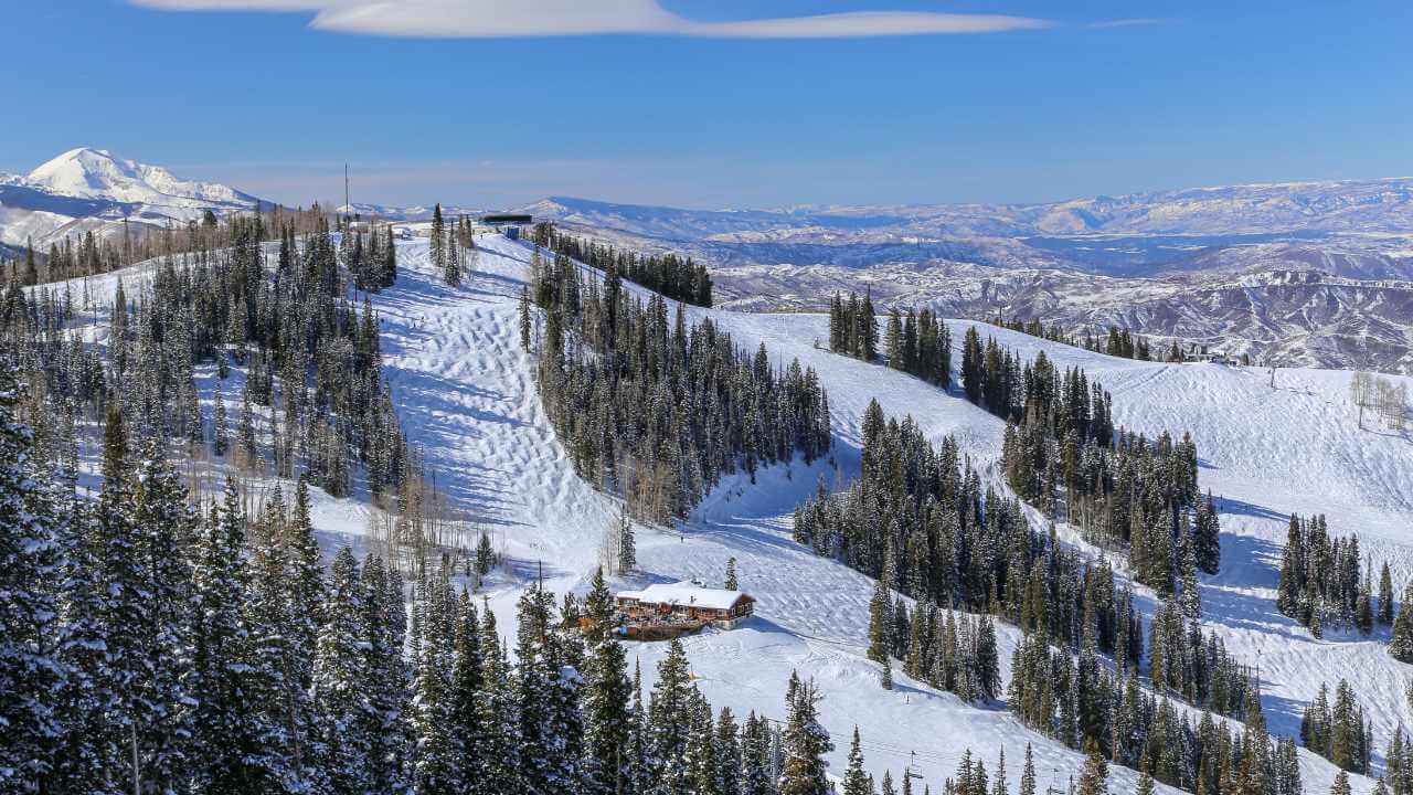 a ski slope is covered with snow and trees