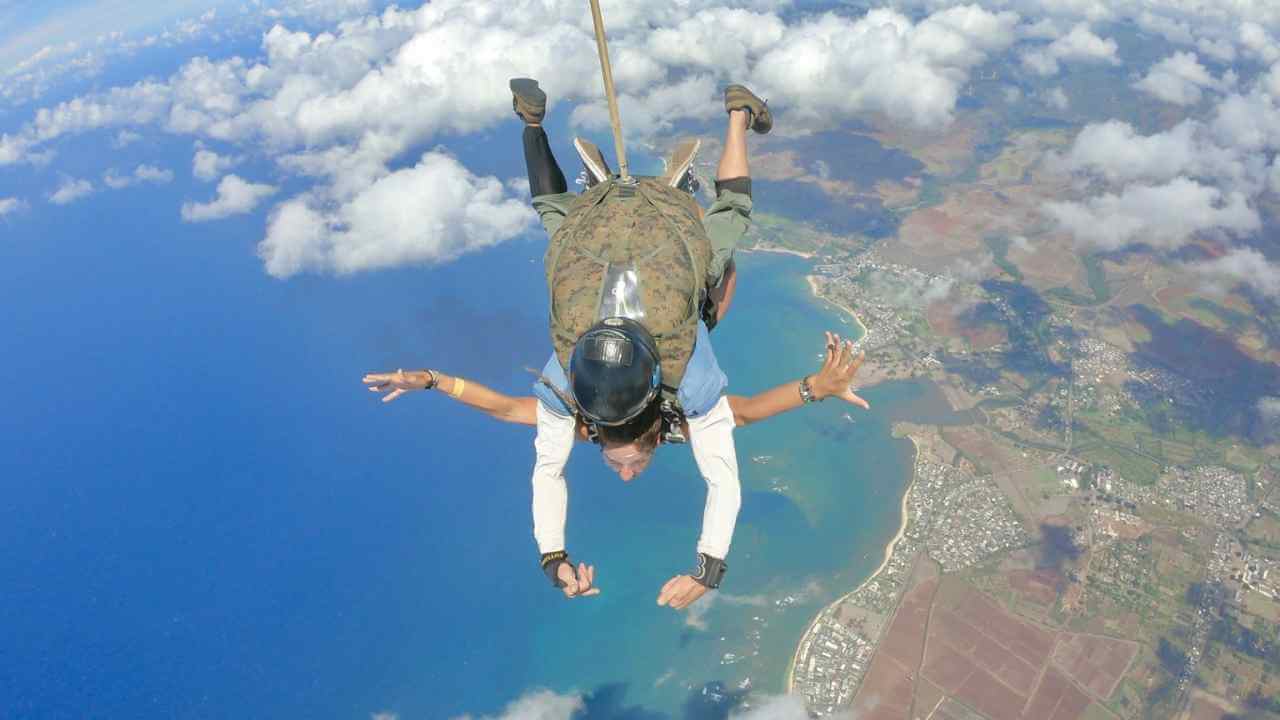 a skydiver in the air with arms outstretched