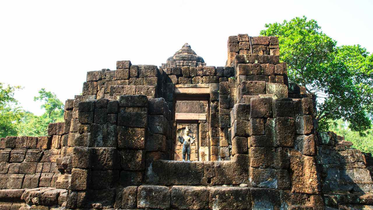 Ancient stone temple ruins surrounded by trees at a hidden historical site