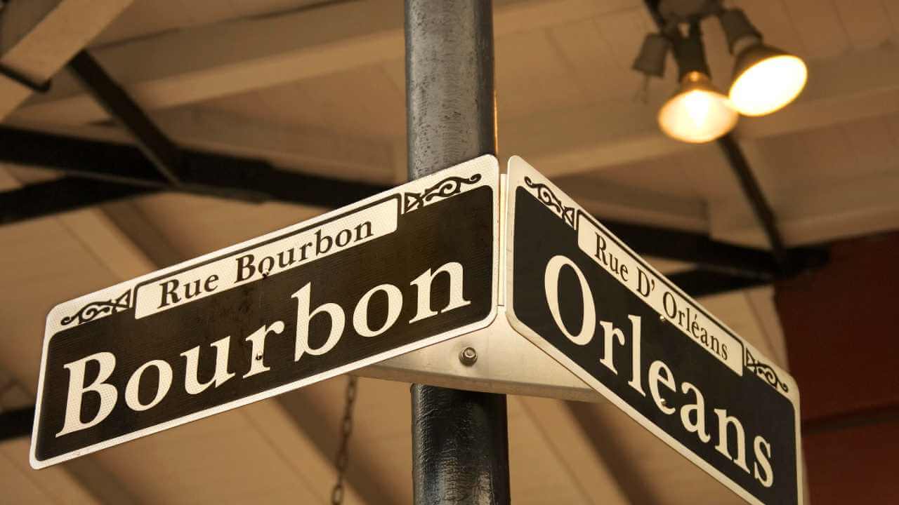 a street sign with the words bourbon and orleans on it