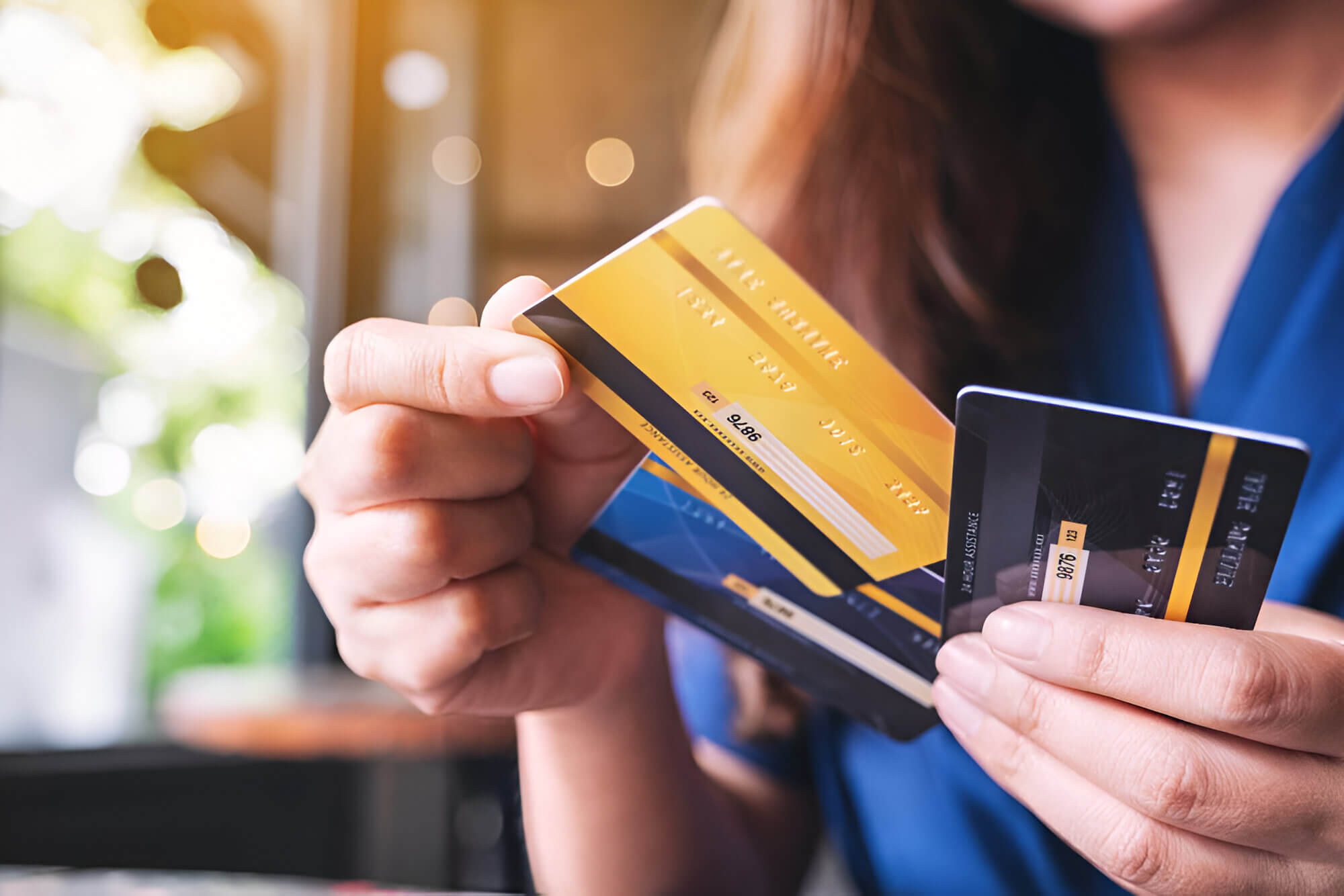 person holding multiple credit cards