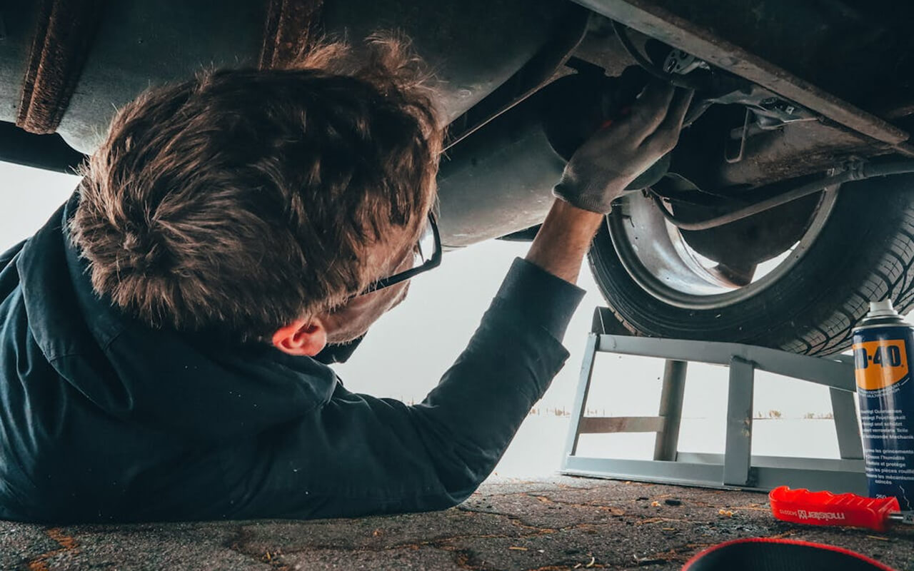Mechanic working under a car