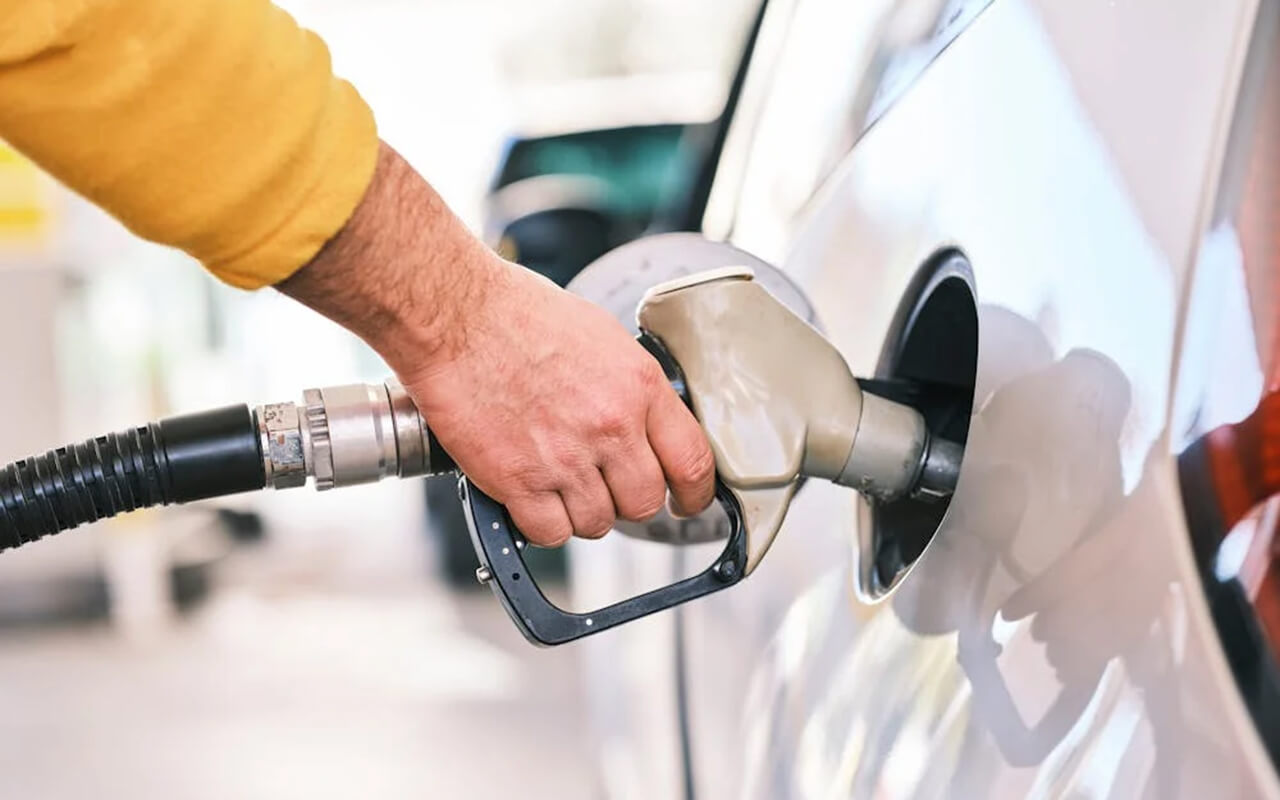 Person filling up their car with gas
