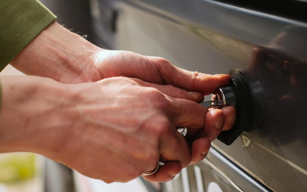Person unlocking a door with a key