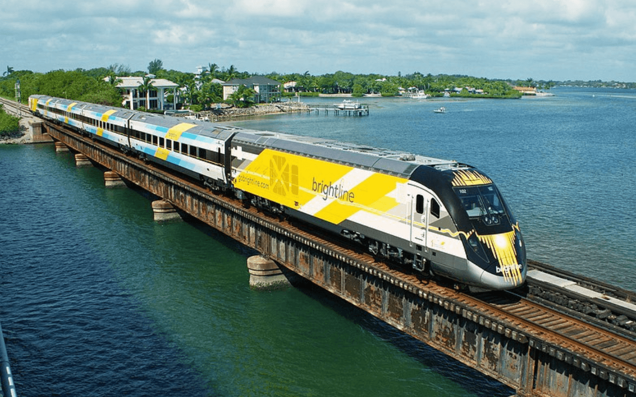 aerial view of the brightline train going over water