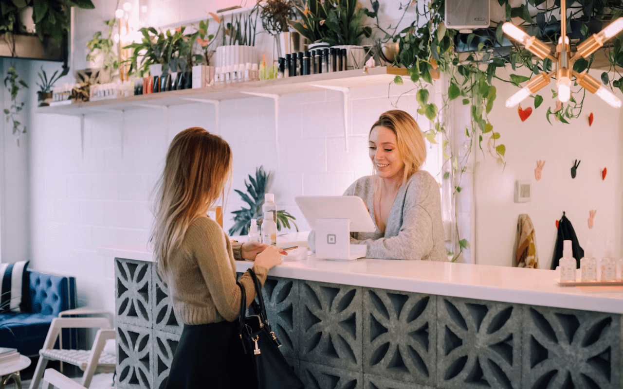 person talking to worker at a counter