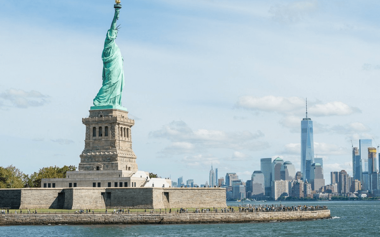 statue of liberty and view of new york city skyline